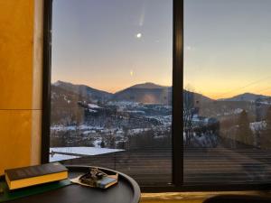 a window with a view of a snowy mountain at CloudBase in Tukhlya