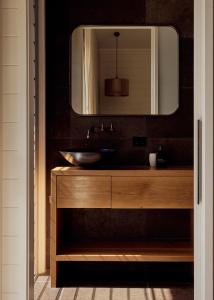 a bathroom with a sink and a mirror at 28 Degrees Byron Bay - Adults Only in Byron Bay