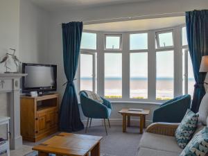 a living room with a view of the ocean at Wild Waves in Hornsea