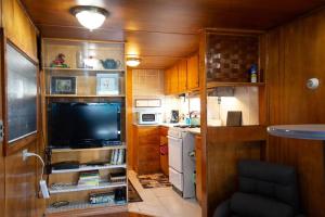 una pequeña cocina con TV en una casa pequeña en Vintage Trailer - Cute Spot for Budget Travelers en Anchorage