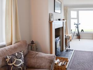 a living room with a couch and a fireplace at Egypt in Newbigging