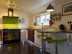 a kitchen with a counter and a stove top oven at The Old Bakery in Pulham Saint Mary Magdalene