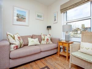 a living room with a couch and a chair at The Lookout in Salcombe