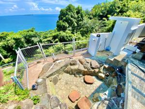 an outdoor bathroom with a view of the ocean at 露天風呂オーシャンビューBlue Ocean IZU in Ajiro +19 photos