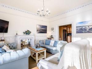 a living room with white furniture and a chandelier at Apartment 1 - Uk32244 in Aberdyfi