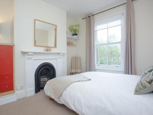 a bedroom with a bed and a fireplace at Haldon View in Lympstone