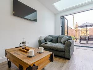 a living room with a couch and a coffee table at Wynbec Cottage in Esh