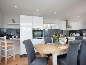 a kitchen with a wooden table and chairs at Moornook 7-uk36703 in Newton Abbot
