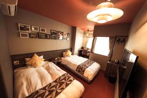 ein Hotelzimmer mit 2 Betten und einem Fenster in der Unterkunft HALE Kyoto Toji#Tabist in Kyoto