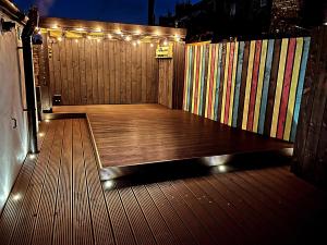 a wooden deck with lights on top of it at Ballypride in Girvan