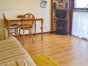 a living room with a table and a fireplace at Chalet 1 - Uk30302 in Tore