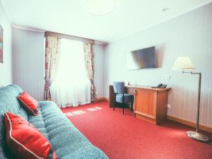 a hotel room with a couch and a desk at Boutique Hotel Countries in Samara