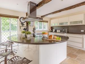 a kitchen with a large island in the middle at Yew Tree Farm in Charing