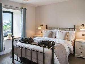 a bedroom with a bed with towels on it at Birkshaw Barn in Bardon Mill