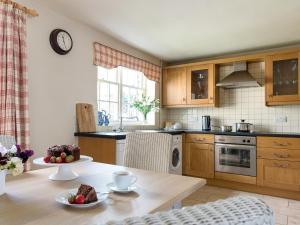 a kitchen with a table with a cake on it at Levisham in Pickering