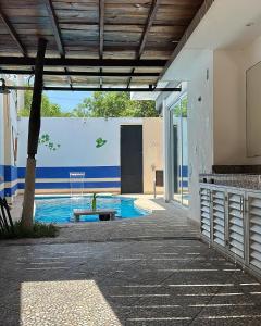 a swimming pool in a building with a wall with at Cancún Hotel Boutique & Hostel in Cancún