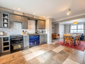 a kitchen with a table and a dining room at Kildonan in Durnamuck