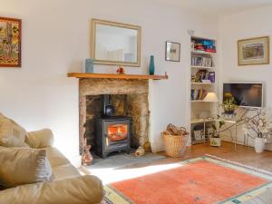 a living room with a fireplace and a couch at Craigclunie in Ballater