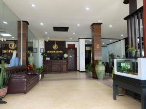 a lobby with a couch and a tv in a building at SUBINH HOTEL AND RESTAURANT in Pakse