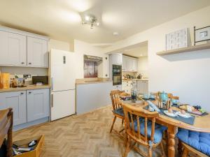 a kitchen and dining room with a table and chairs at Valley View in Malvern Wells