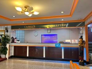 a lobby with a cashier and a counter at Asia Grand Hotel in Hat Yai