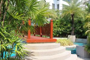 a set of stairs leading to a pool with palm trees at WERT in Phuket