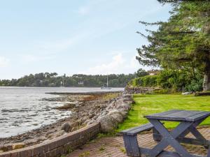 una mesa de picnic sentada junto a un cuerpo de agua en Dundonald Landing - Palm 3 - Uk35430, en Connel