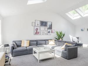 a living room with a couch and a table at High Trees View in Knaresborough