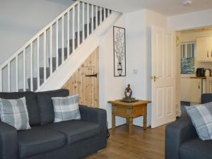 a living room with a couch and a staircase at Mountain View in Blaenau-Ffestiniog