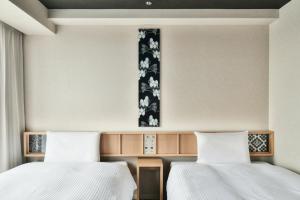 Ein Bett oder Betten in einem Zimmer der Unterkunft REF Matsuyama City Station by VESSEL HOTELS