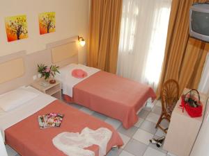 Ένα ή περισσότερα κρεβάτια σε δωμάτιο στο Hotel Calypso