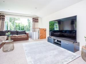 a living room with a large flat screen tv at Devon Sands in Paignton