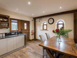 a kitchen and dining room with a wooden table at Cedar Barn - Uk33352 in Buttershaw