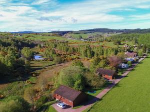 an aerial view of a village with a river and trees at Treetops Lodge - Uk30556 in Urchany