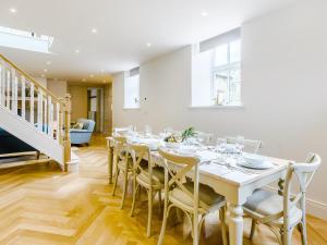 a white dining room with a white table and chairs at The Old Chapel in Slaley