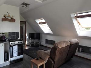 a living room with a couch and a stove at Marshfield Annex in Wingfield