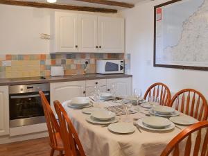 a kitchen with a table with plates and wine glasses at Purlinney in Treknow