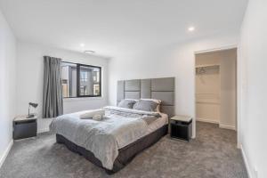 a bedroom with a large bed and a window at Three bedroom Townhouse in O'connor ACT in Canberra
