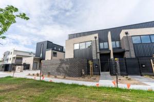 a building with a fence in front of it at Three bedroom Townhouse in O'connor ACT in Canberra
