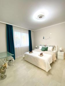 a bedroom with a large bed with two teddy bears on it at Luna Rossa Boutique Apartman in Balatonakali