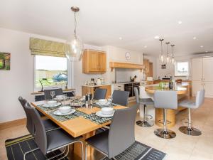 a kitchen and dining room with a table and chairs at Morven View in Dunbeath
