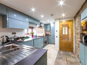 a kitchen with blue cabinets and a sink at Foxes Reach in Trelleck