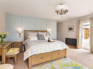 a bedroom with a large bed and a window at Morven View in Dunbeath