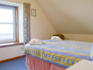 a bedroom with a bed with two towels on it at Seabreezes - Uk30690 in Portknockie