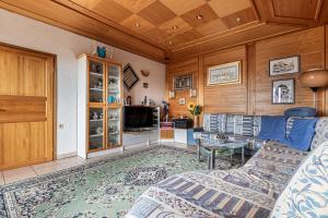 a living room with a couch and a table at Pool Villa Adonis - Happy Rentals in Semič