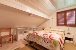 a bedroom with a bed and a chair and a window at Pool Villa Adonis - Happy Rentals in Semič