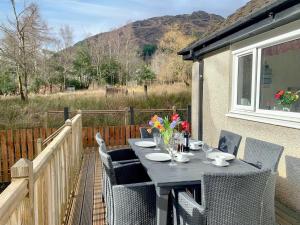 a table and chairs on the patio of a house at Torr Caladh in Glenfinnan