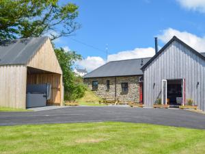 a barn with a garage and a building at Stambar in Llanglydwen