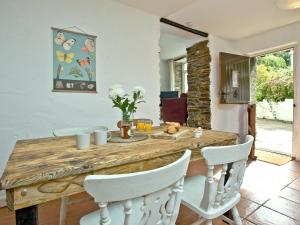 a dining room with a wooden table and white chairs at Stables - Uk31176 in Saint Martin