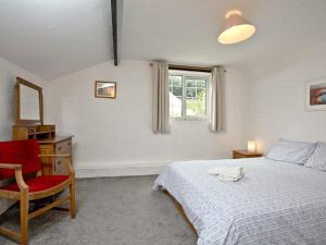 a bedroom with a bed and a chair and a window at Stables - Uk31176 in Saint Martin